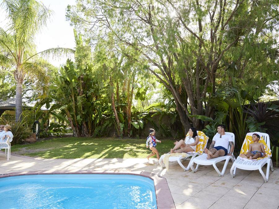 A poolside area with lounge chairs and a swimming pool.