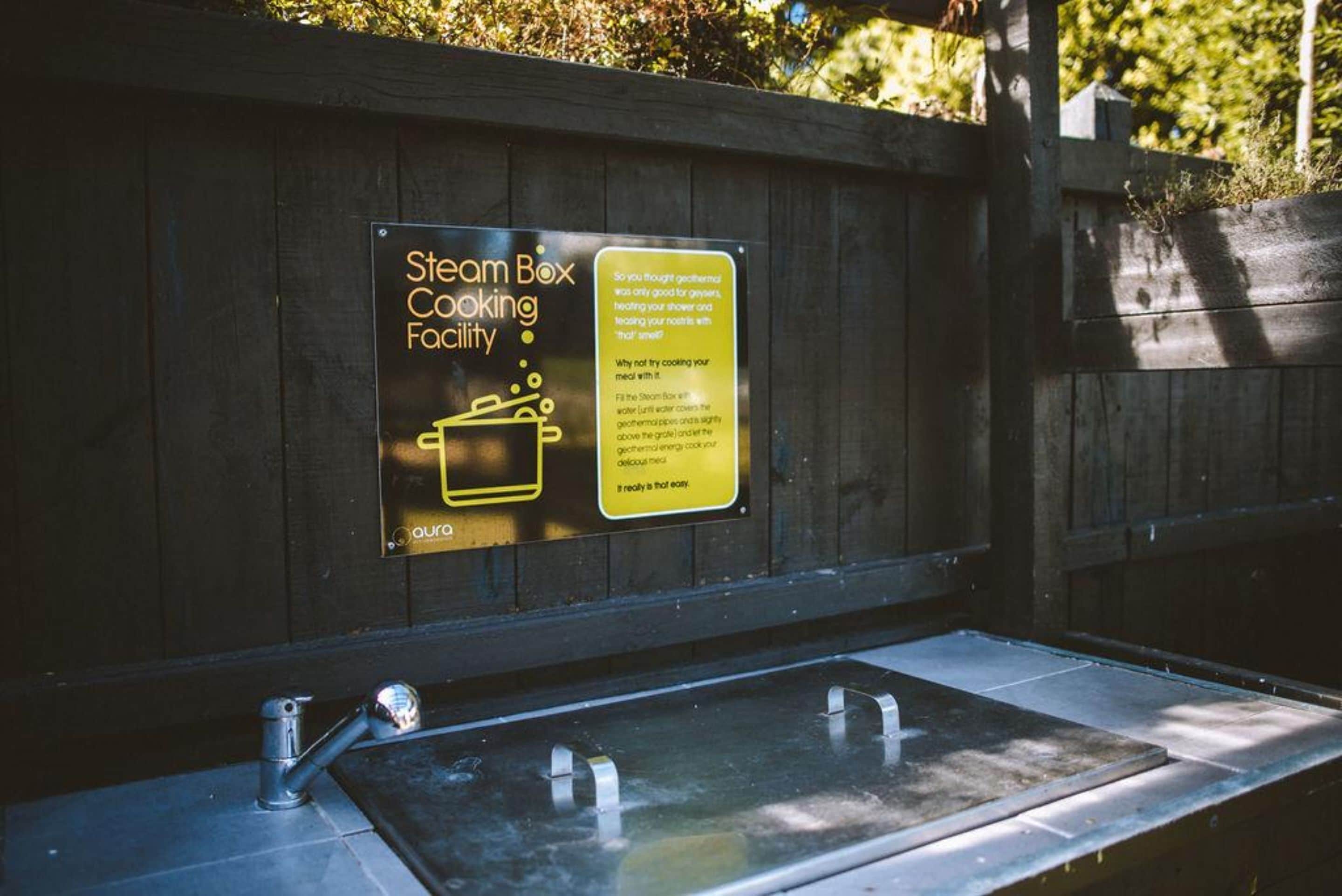 A steam box cooking facility with a sign explaining its use.