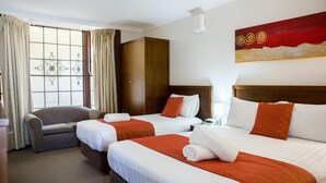 A hotel room with two beds, a sofa, a wardrobe, and a window with curtains. - Colonial Lodge Motor Inn Yass (Yass)