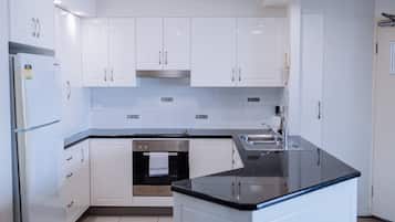 Two Bedroom Apartment | Private kitchen | Full-size fridge, microwave, oven, stovetop