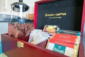 A drawer containing tea bags, sugar packets, and a menu for breakfast options. - Foreshore Motor Lodge (Lower Hutt)