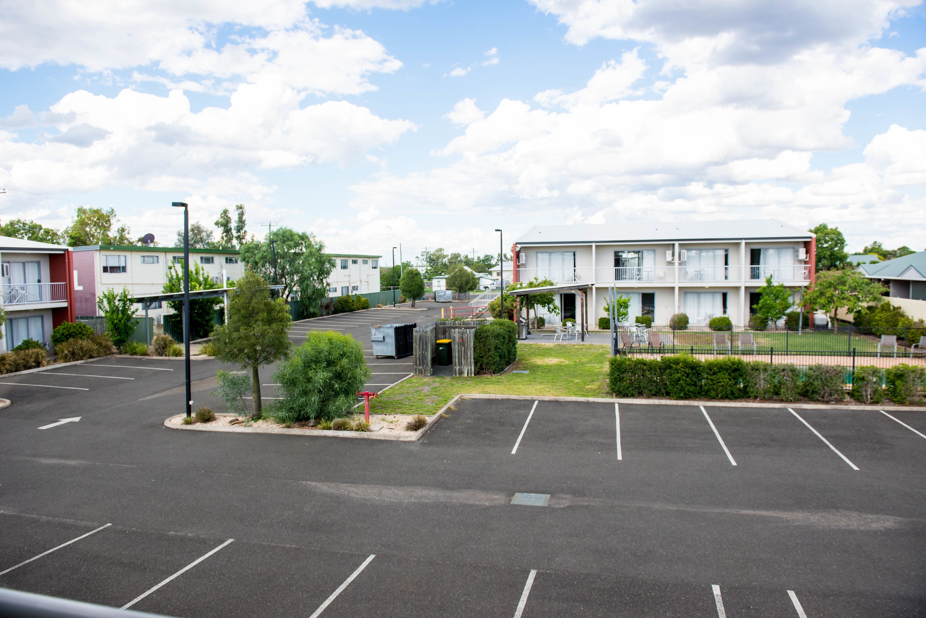 A parking lot with a building in the background.