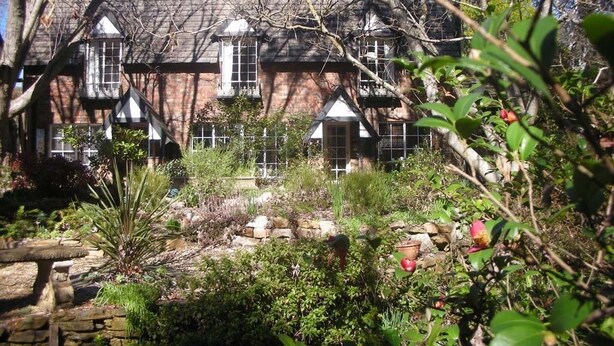 A traditional brick house with multiple windows and a garden in front. - Merrimeet Cottages (Bright)