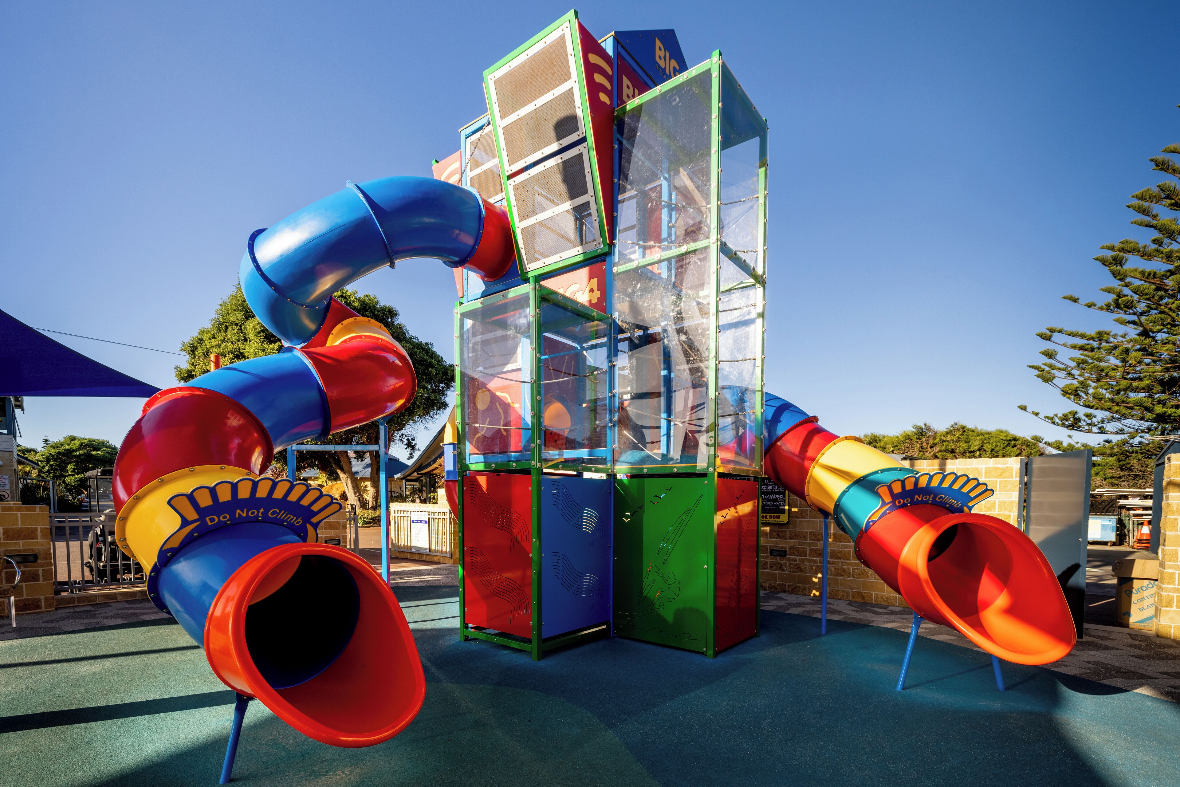 A playground with a slide and climbing structures.