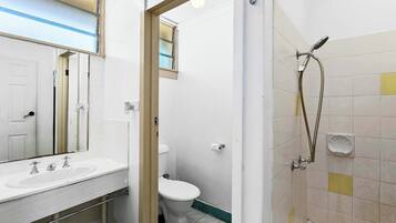 A bathroom with a sink, toilet, and shower.