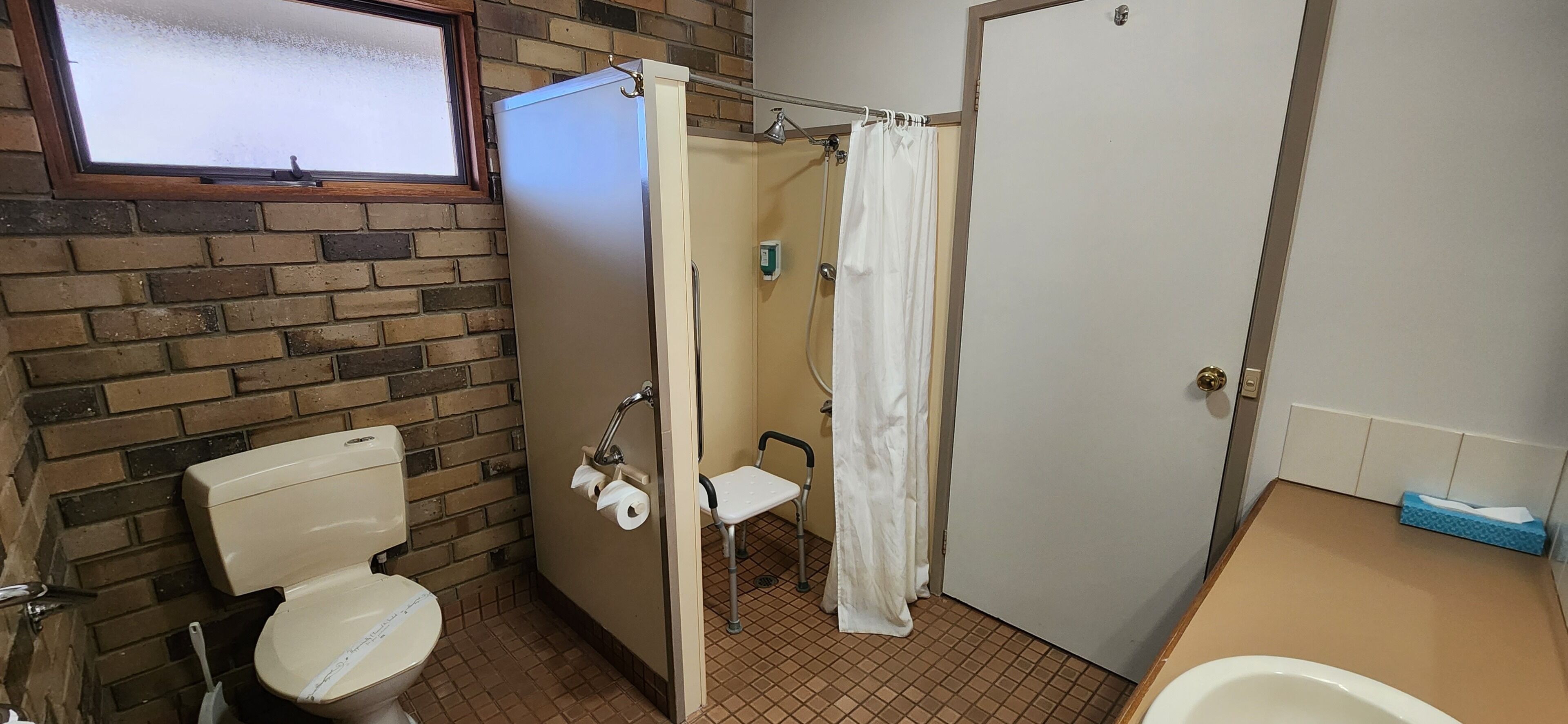 A bathroom with a toilet, a shower, and a bathtub.