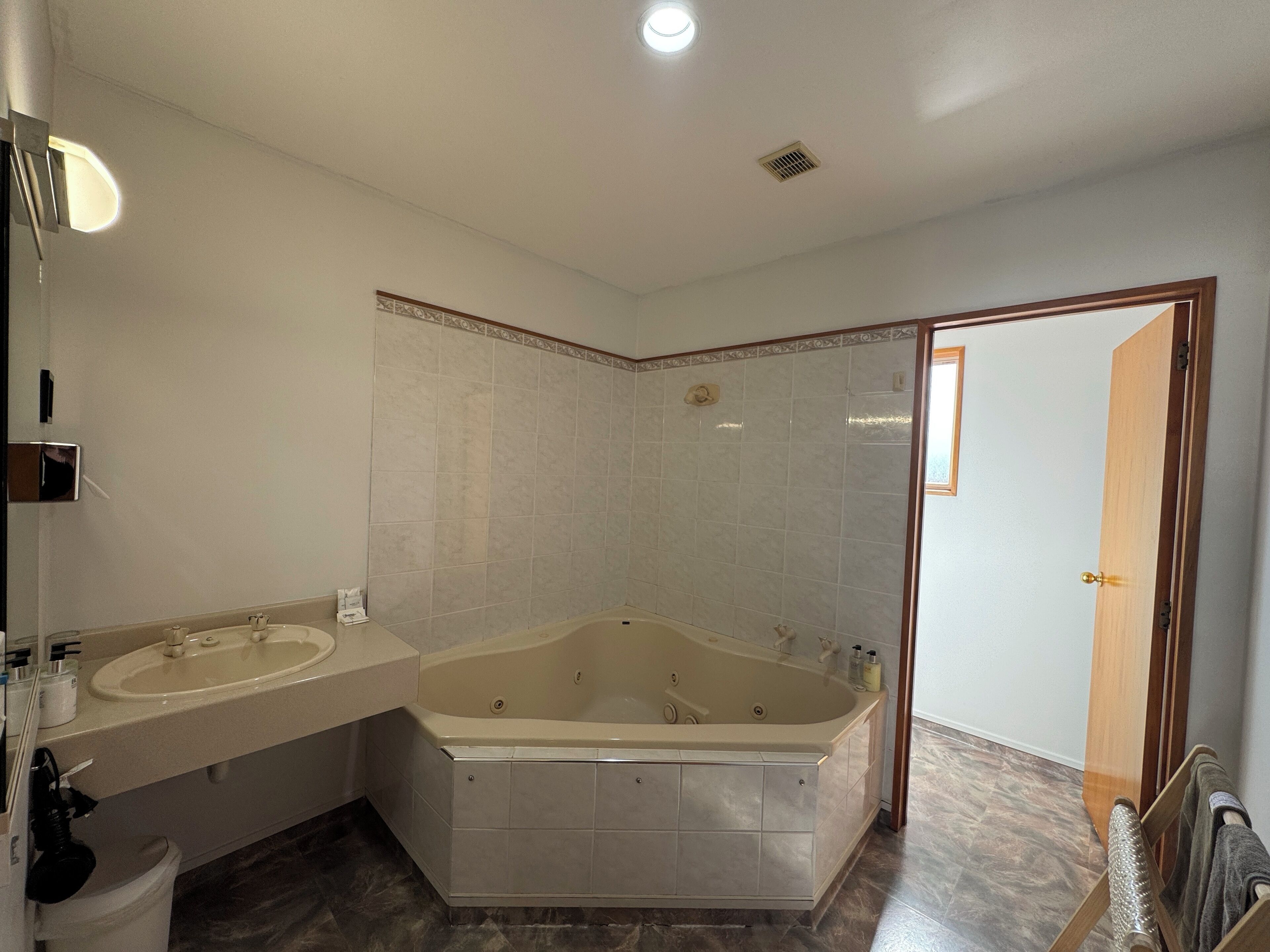 Un baño con bañera, dos lavamanos y ducha.