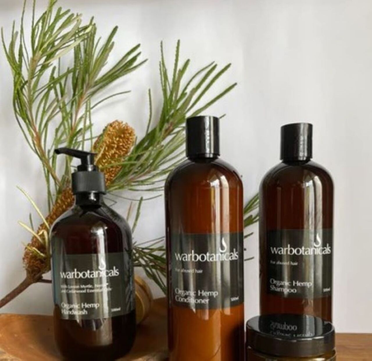Three bottles of Warbotanics organic hemp hair products.