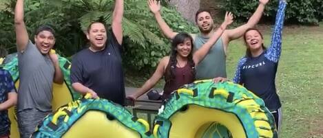 A group of people holding large inflatable rings outdoors.
