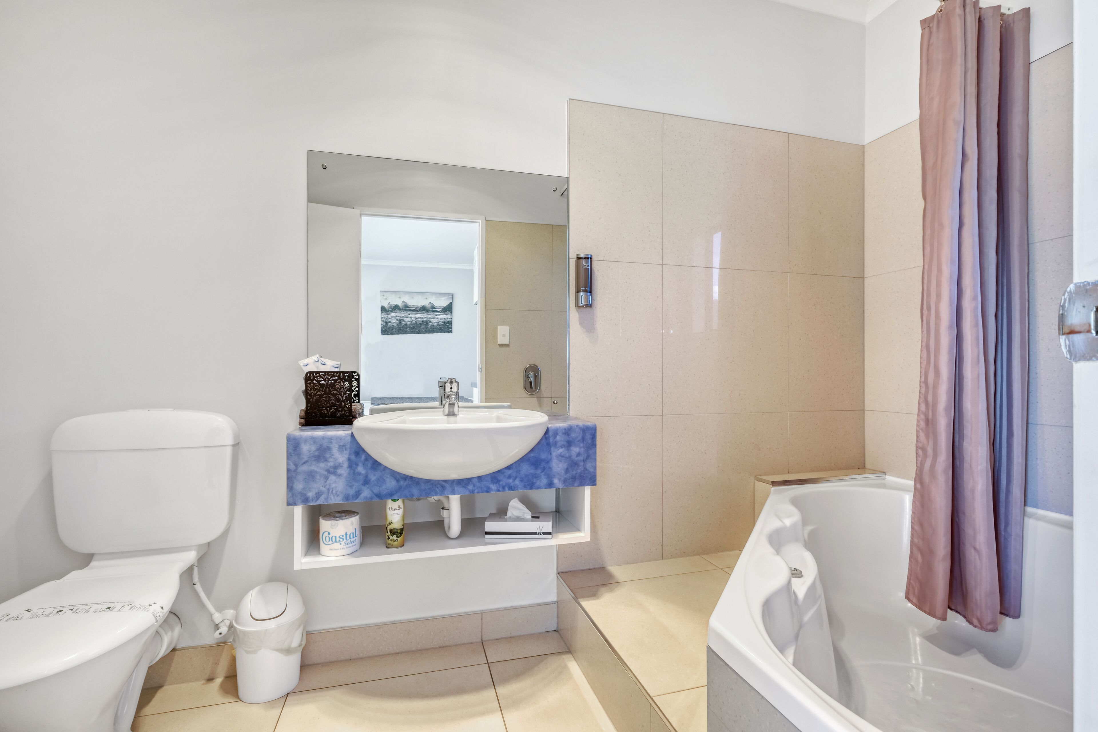 A bathroom with a toilet, sink, and bathtub.