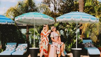 Seasonal outdoor pool, open 8:00 AM to 9:00 PM, pool umbrellas