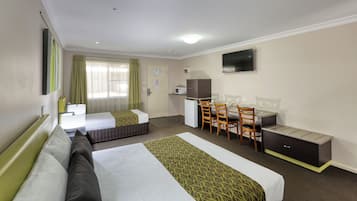 A hotel room with two beds, a desk, a chair, a television, and a microwave.