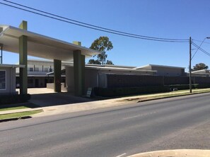 A gas station with a canopy and a building in the background. - Drover's Motor Inn, Dalby (Dalby)