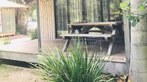 A covered outdoor area with a wooden picnic table and a wooden structure labeled "Cuckoo." - Lighthouse Beach Holiday Village (Port Macquarie)