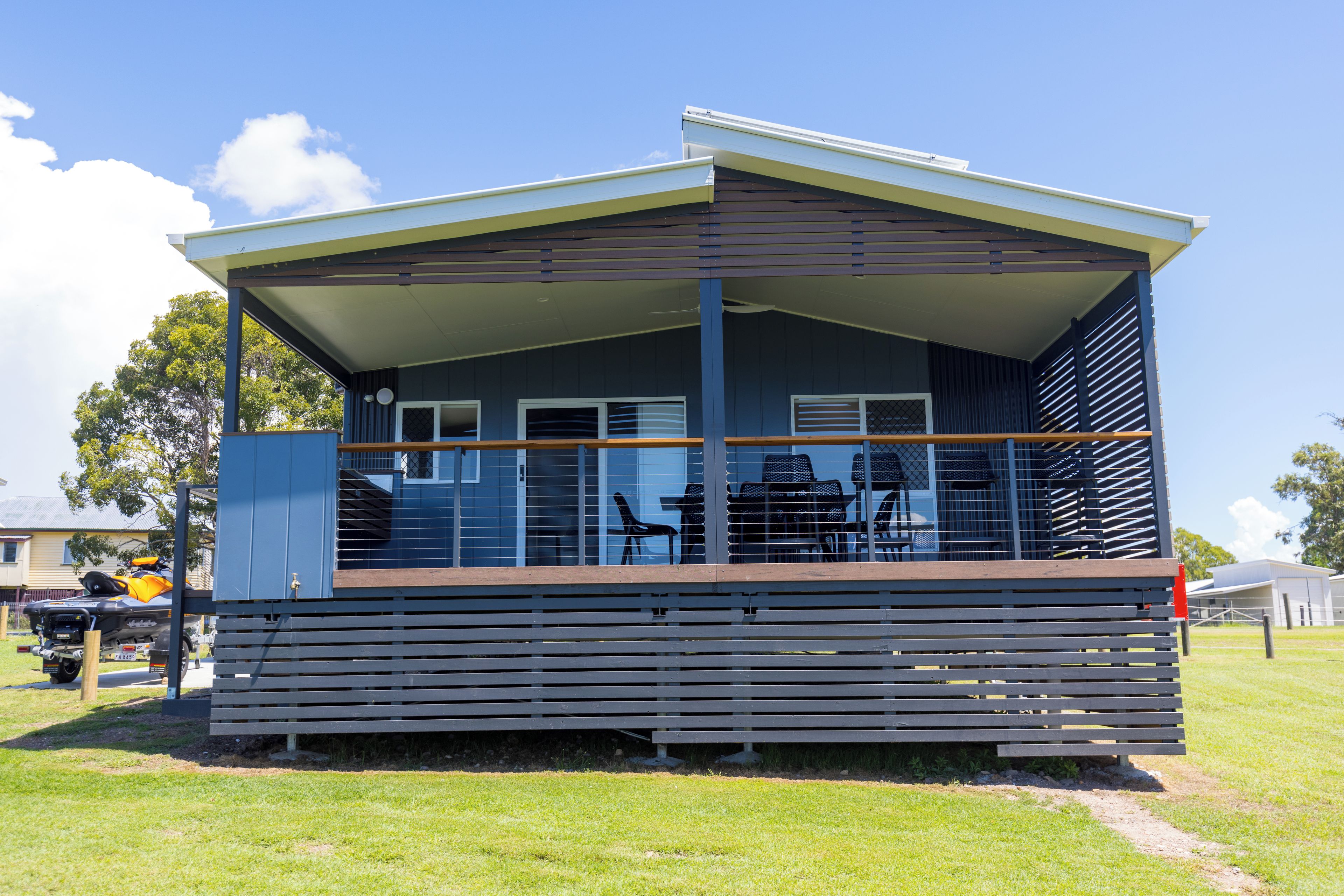 A single-story building with a flat roof and a covered porch.