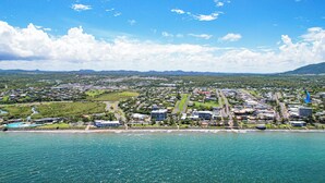 A coastal cityscape with a marina, residential areas, and a large building complex.