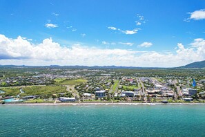 A coastal cityscape with a marina, residential areas, and a large building complex.