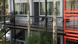 A modern two-story building with a balcony, large windows, and a staircase. - A1 Inn the City (Cairns)