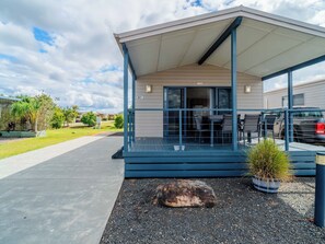 A single-story building with a covered porch and a patio area.