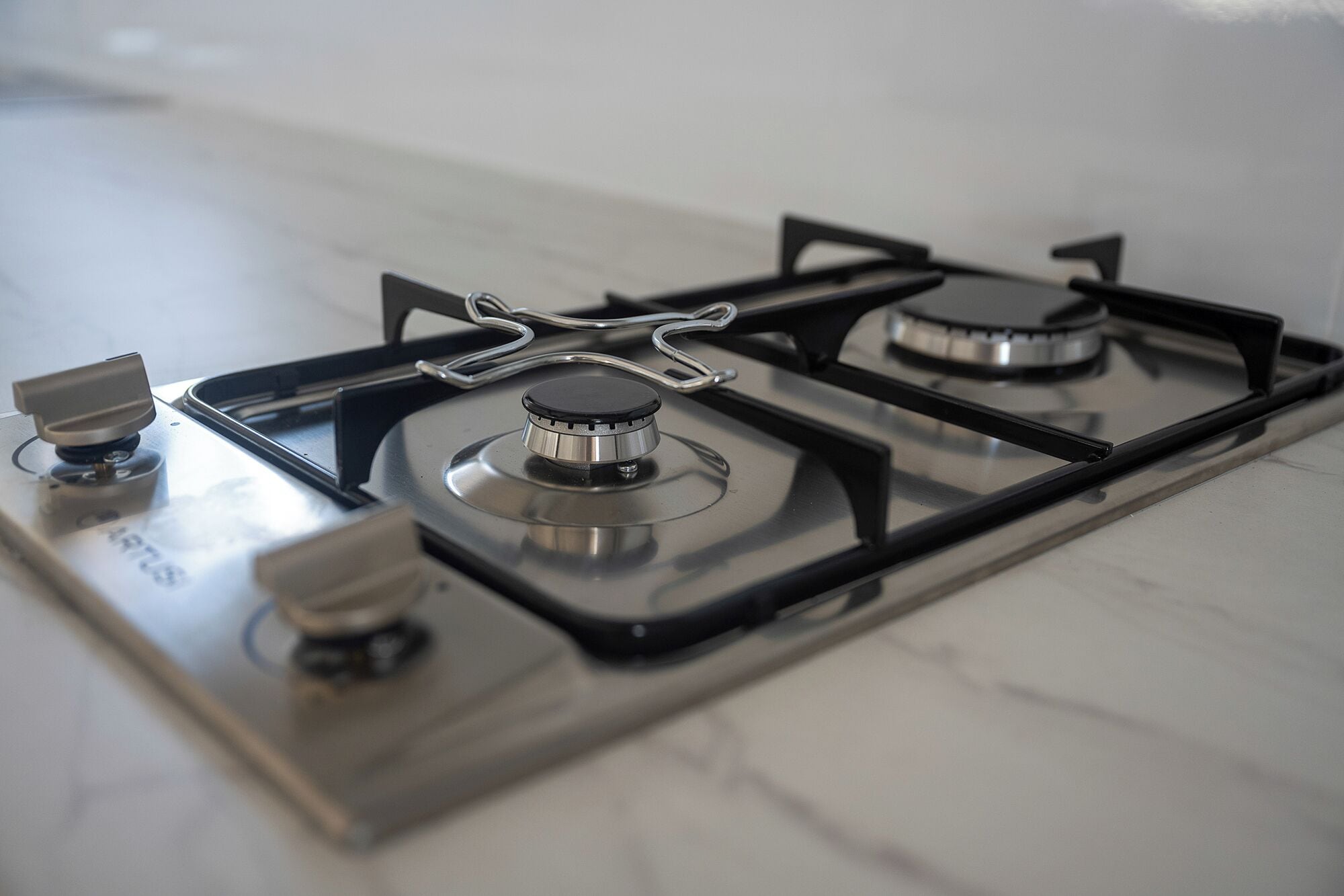 A gas stove with four burners and a control knob.