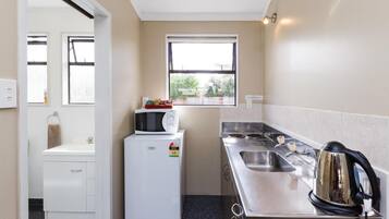 Fridge, microwave, coffee/tea maker, cookware/dishes/utensils