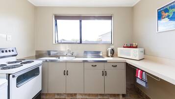 Fridge, microwave, coffee/tea maker, cookware/dishes/utensils