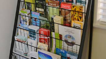 A promotional display rack with various travel brochures and maps, including a visible 'Manning Valley' sign.
