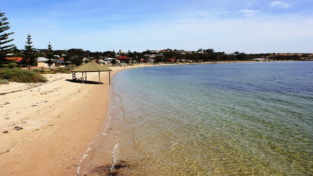 A beach with clear water, a sandy shore, and a gazebo. - Port Vincent Motel & Apartments (Port Vincent)