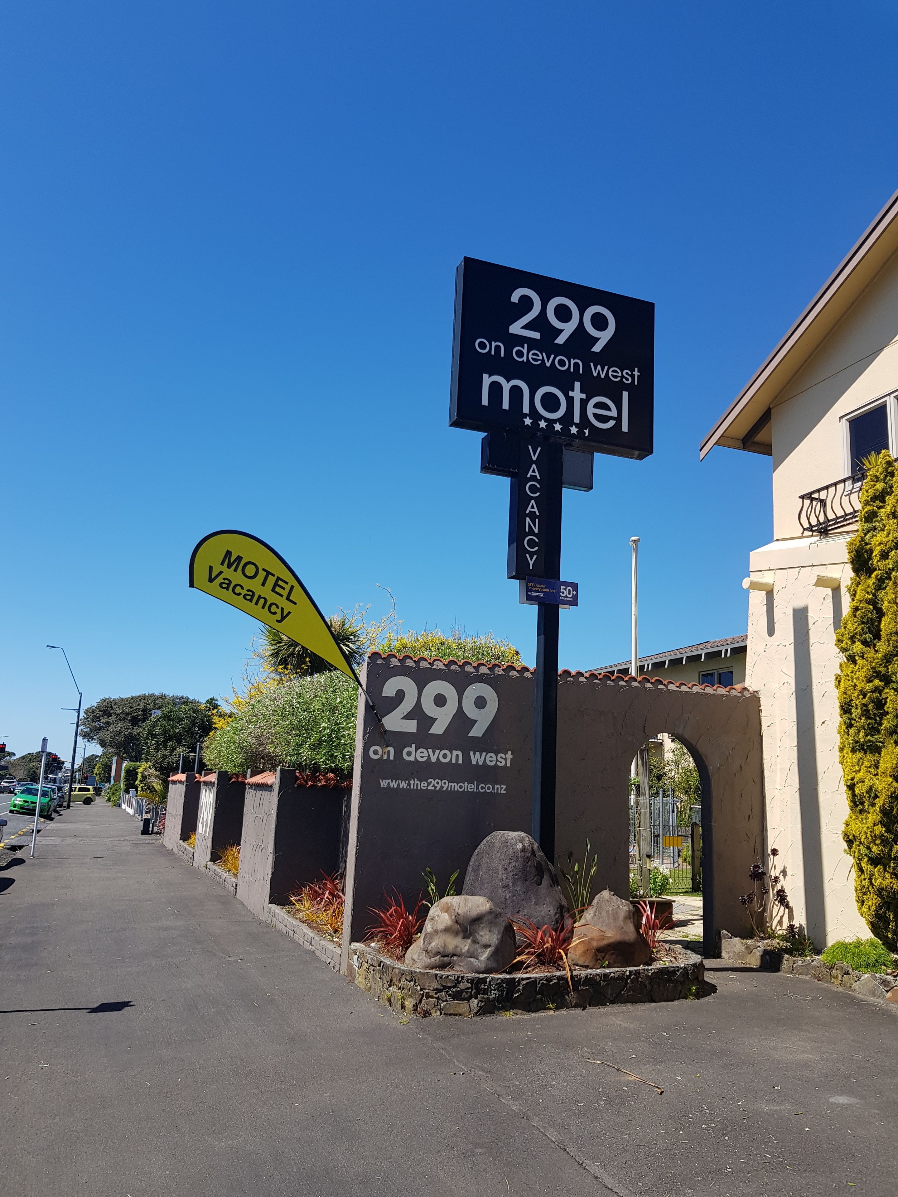 A motel sign with the number 299 on Devon West, indicating a vacancy.