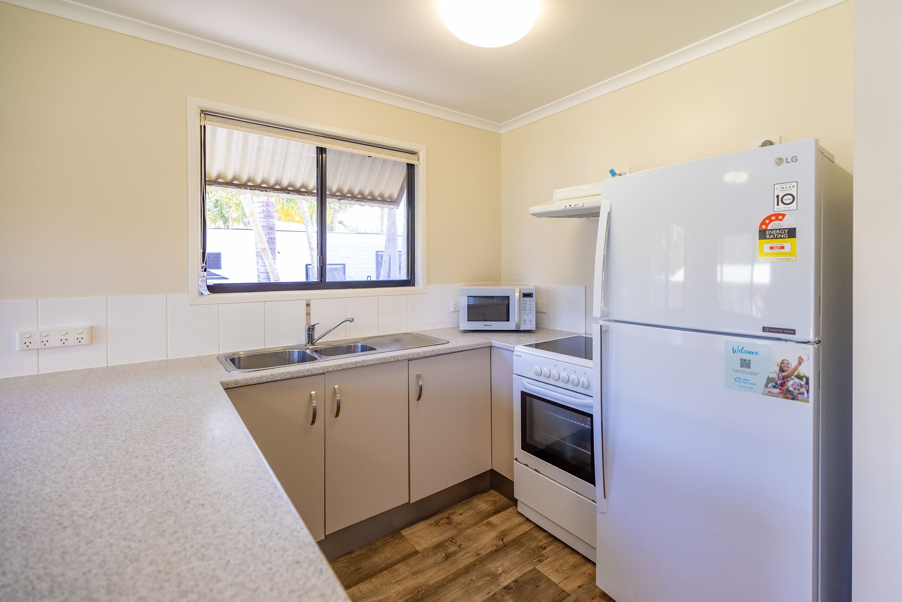 A kitchen with a microwave, stove, and refrigerator.