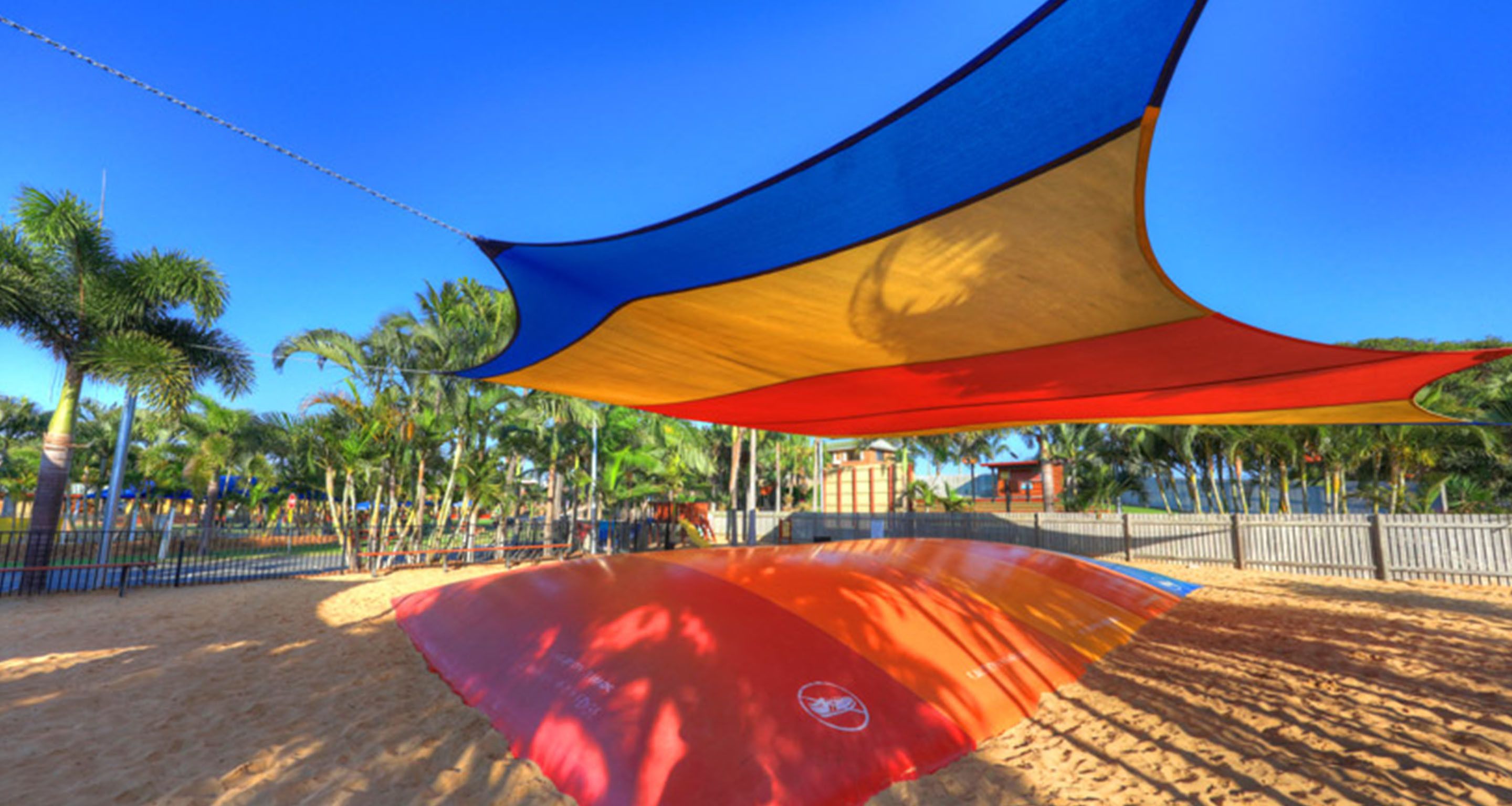 A beach with a colorful canopy structure.