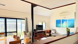 A modern kitchen with a wooden countertop, a built-in oven, and a large window. - The Break, Margaret River Beach Houses (Gnarabup)