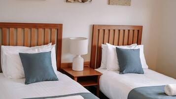 Premium bedding, pillowtop beds, laptop workspace, blackout drapes