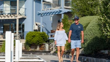Guests can stroll along the boardwalk to a beautifully maintained outdoor space with lush greenery and a scenic view.