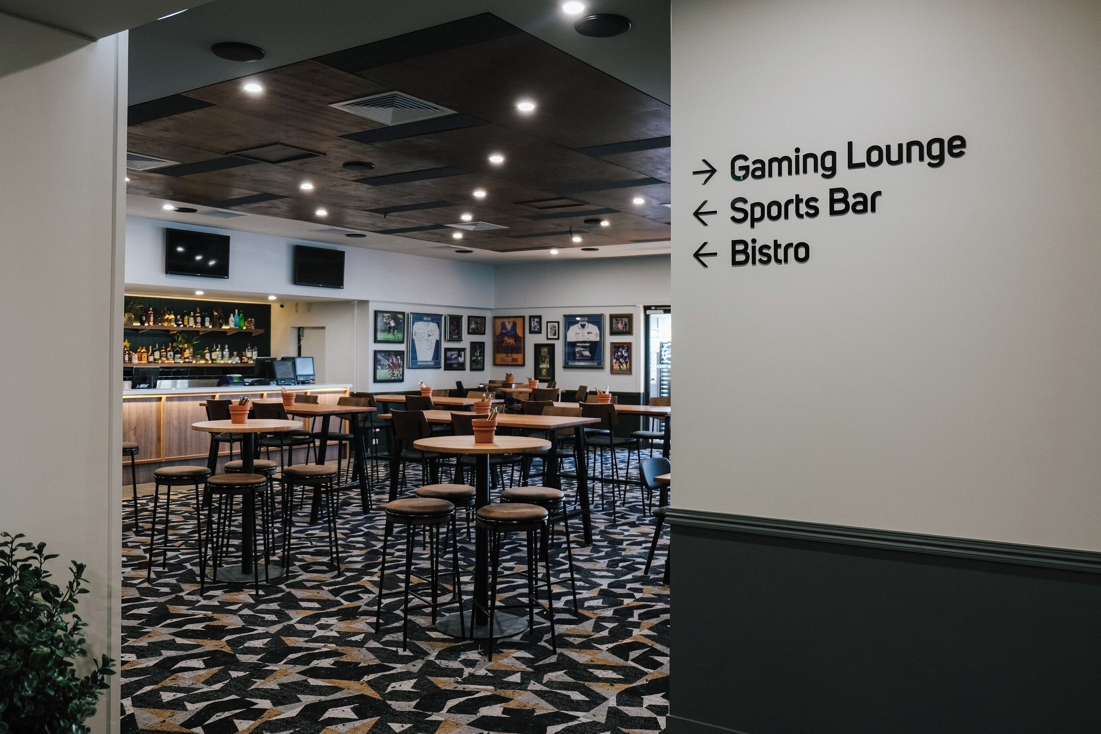 A modern interior with a bar area, gaming lounge, sports bar, and bistro.