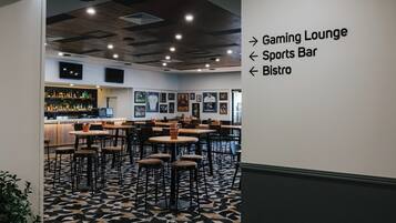 A modern interior with a bar area, gaming lounge, sports bar, and bistro.