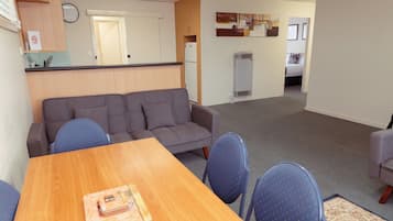 Executive Apartment | Living area | LCD TV, books
