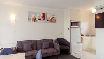 Family Apartment | Living area | LCD TV, books