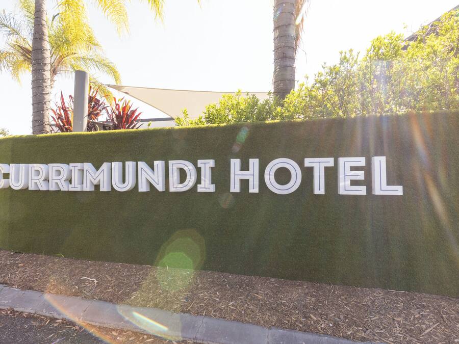 A sign for the Currimundi Hotel with a clear view of the hotel's name.