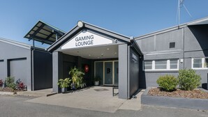 A building with a sign reading "GAMING LOUNGE" at the entrance. - Boomerang Motor Hotel (West Mackay)