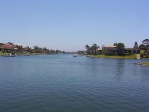 A calm river with boats, houses, and greenery along the banks. - Port O'call Motel (Port Macquarie)