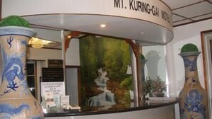 A reception desk with a sign reading "MT. KURING-GAI HOTEL" and a mural of a waterfall. - Mount Kuring-Gai Motel (Mount Kuring-gai)