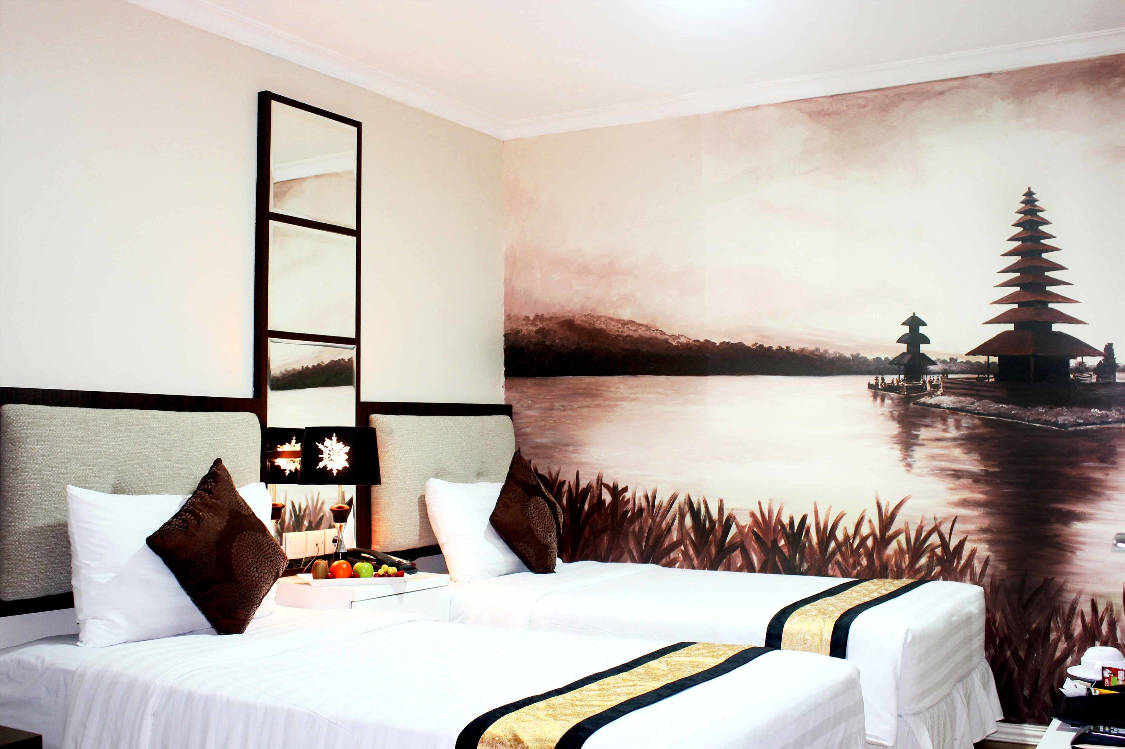 A hotel room with two beds, a large wall mural of a pagoda by a lake, and a modern headboard.
