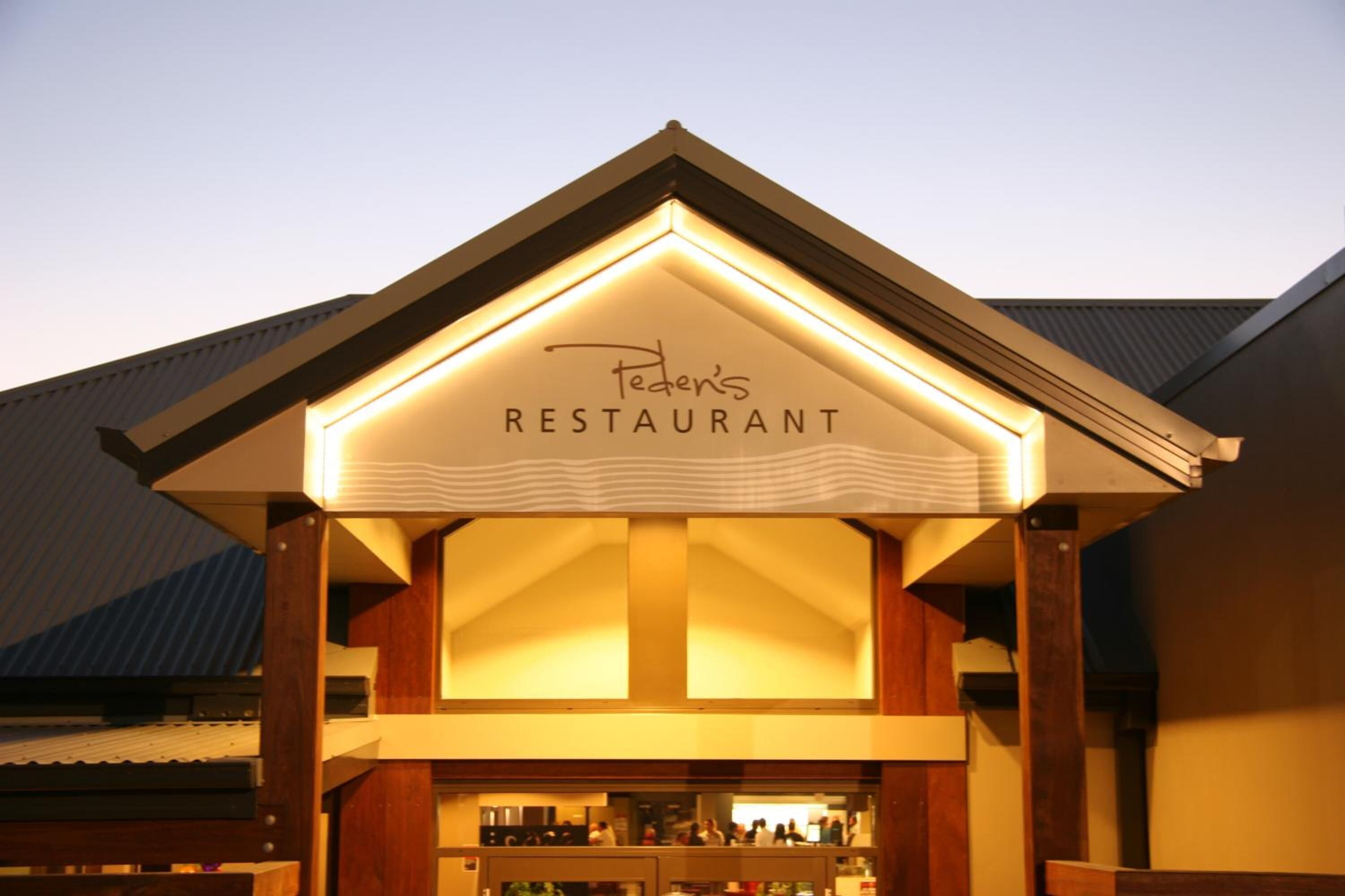 A restaurant with a sign that reads "Feder's Restaurant" under a roofed structure.