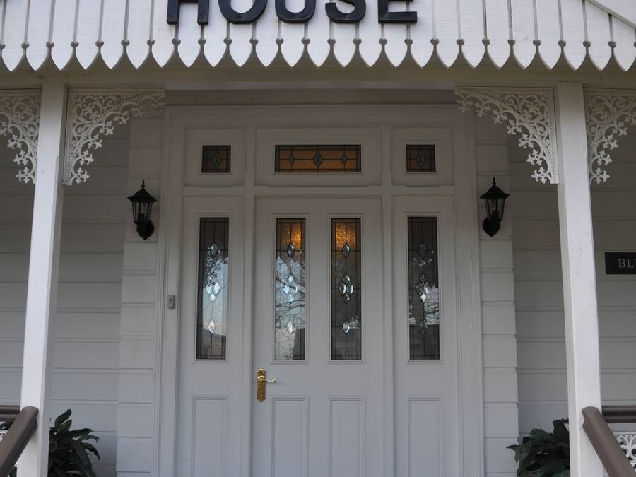 A white building with a sign reading "Bli Bli House" above the entrance.