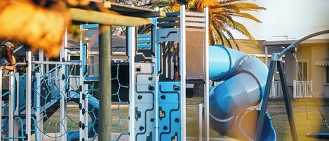A playground with climbing structures and slides.
