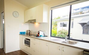 Full-sized fridge, microwave, stovetop, coffee/tea maker