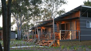 A modern building with a large deck and outdoor seating area. - NRMA Myall Shores Holiday Park (Bombah Point)