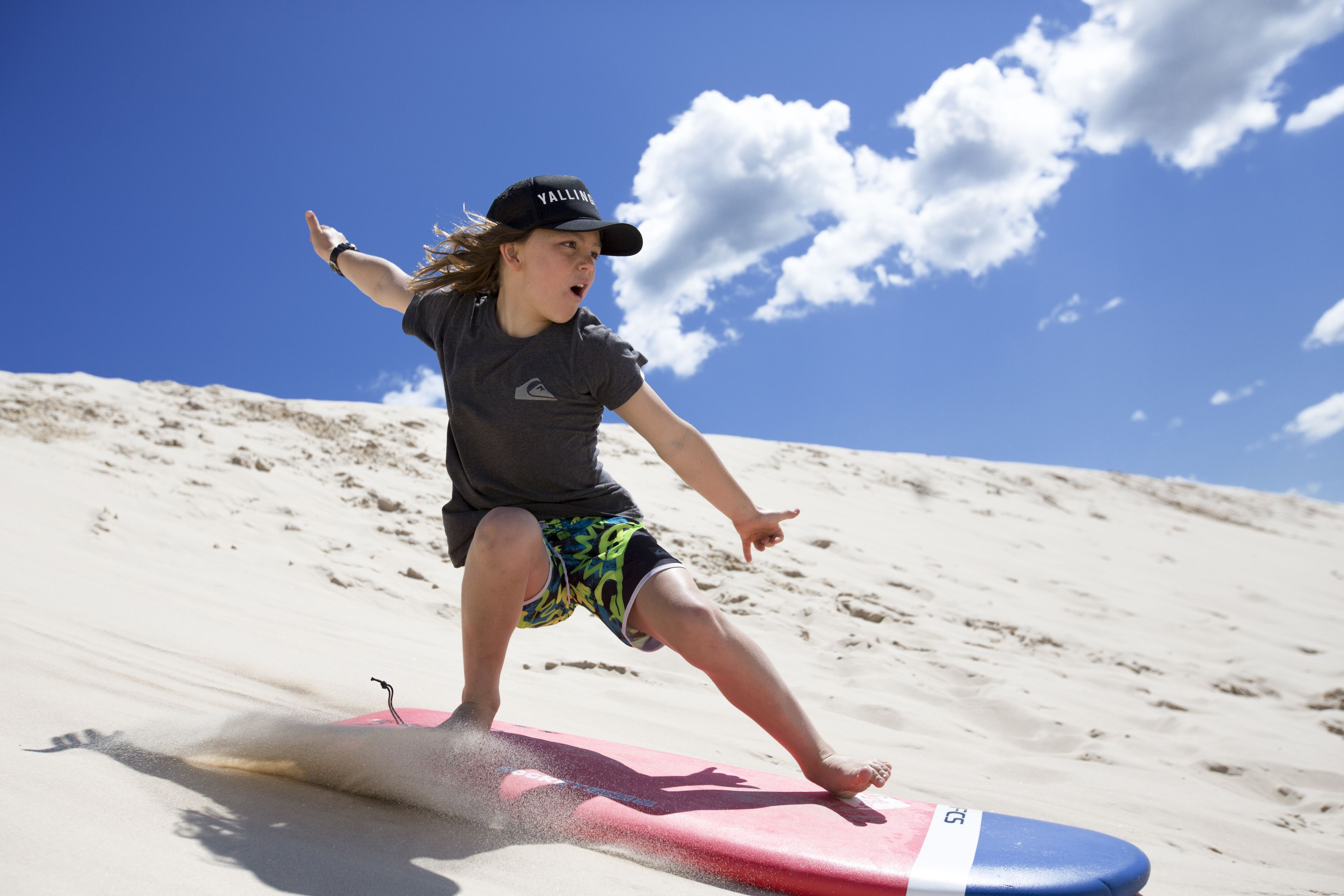 A person on a surfboard at the beach.