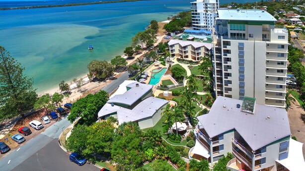 A resort with multiple buildings, a swimming pool, and a beach. - Moorings Beach Resort (Golden Beach)